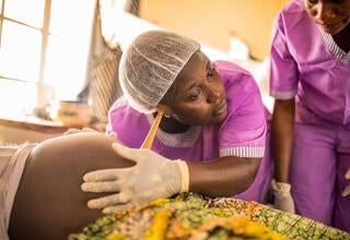 Student midwife checking fetus ©UNFPA Sierra Leone