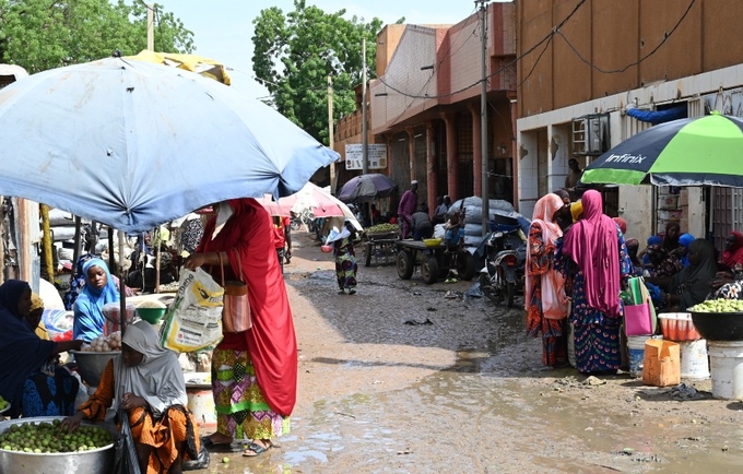 @AFP via Getty Images.Women sell goods at Niamey's main market on 8 August 2023.