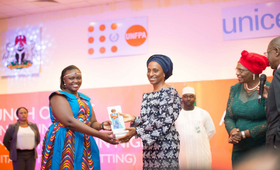 Wife of the Vice President, H.E Mrs. Dolapo Osinbajo presenting the Efua award to the Winner Diana Kendi Makala
