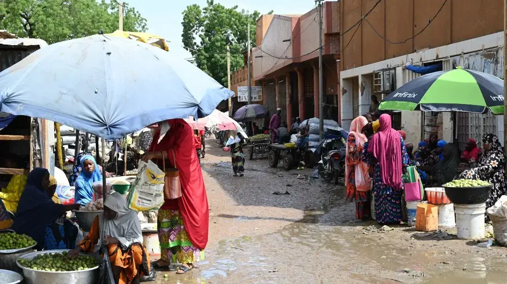 @AFP via Getty Images.Women sell goods at Niamey's main market on 8 August 2023.